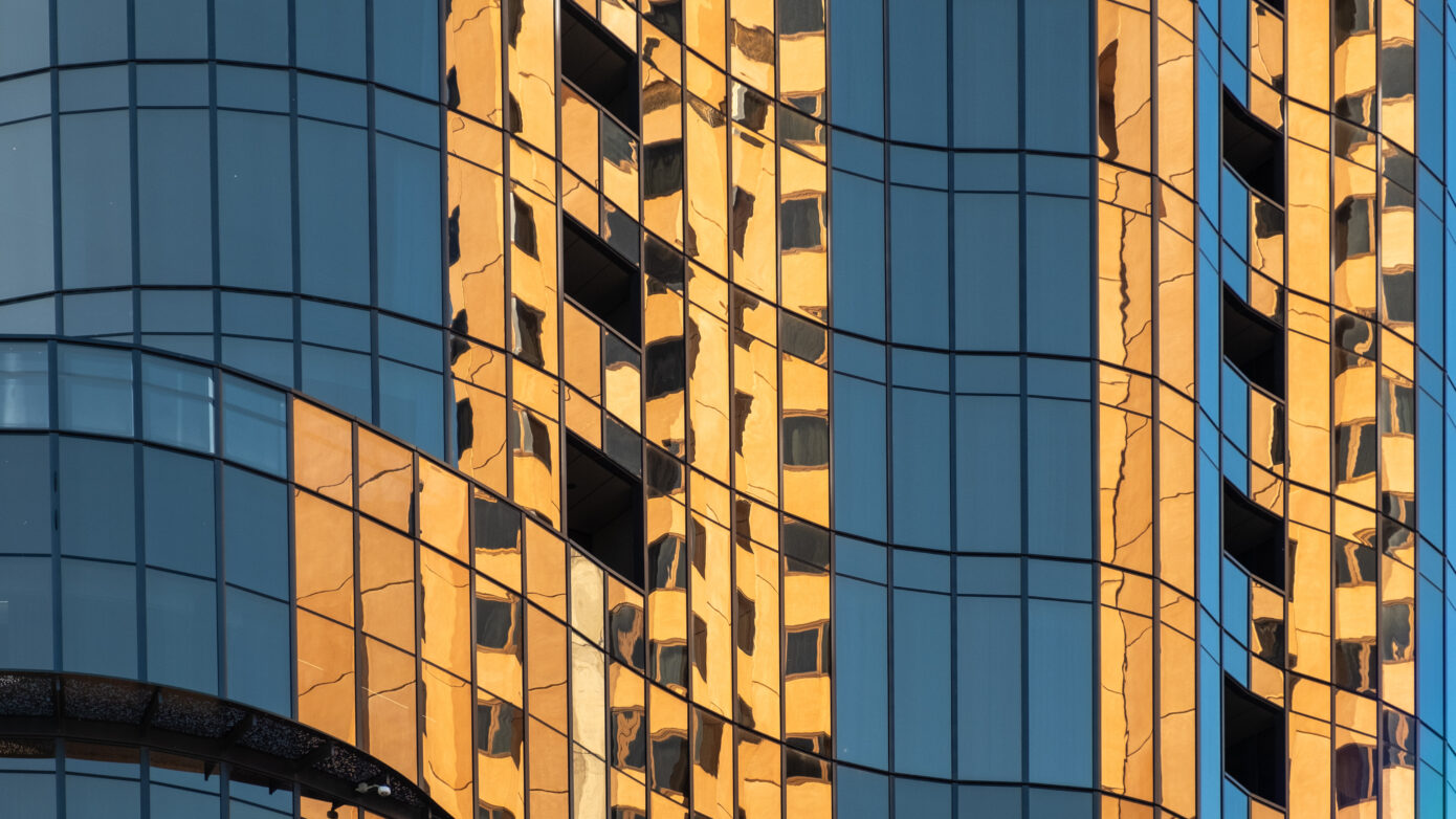 Orange light reflection on glass office building